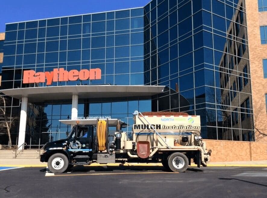 Bark mulch installation truck parked outside Raytheon in Massachusetts